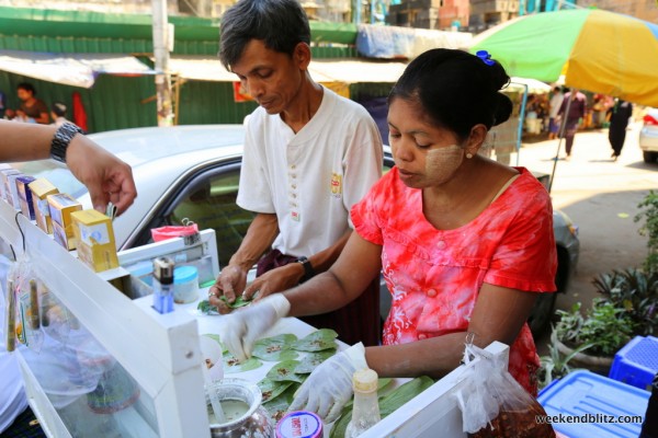 This street cart specializes in making betel quids --  small parcels that typically contain areca nuts wrapped in a betel leaf and coated with lime.